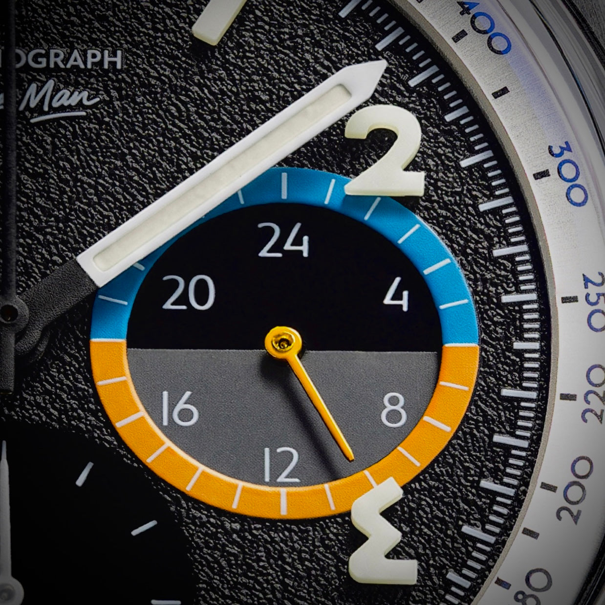 Macro of the textured black dial and the International Orange 24-hour subdial
