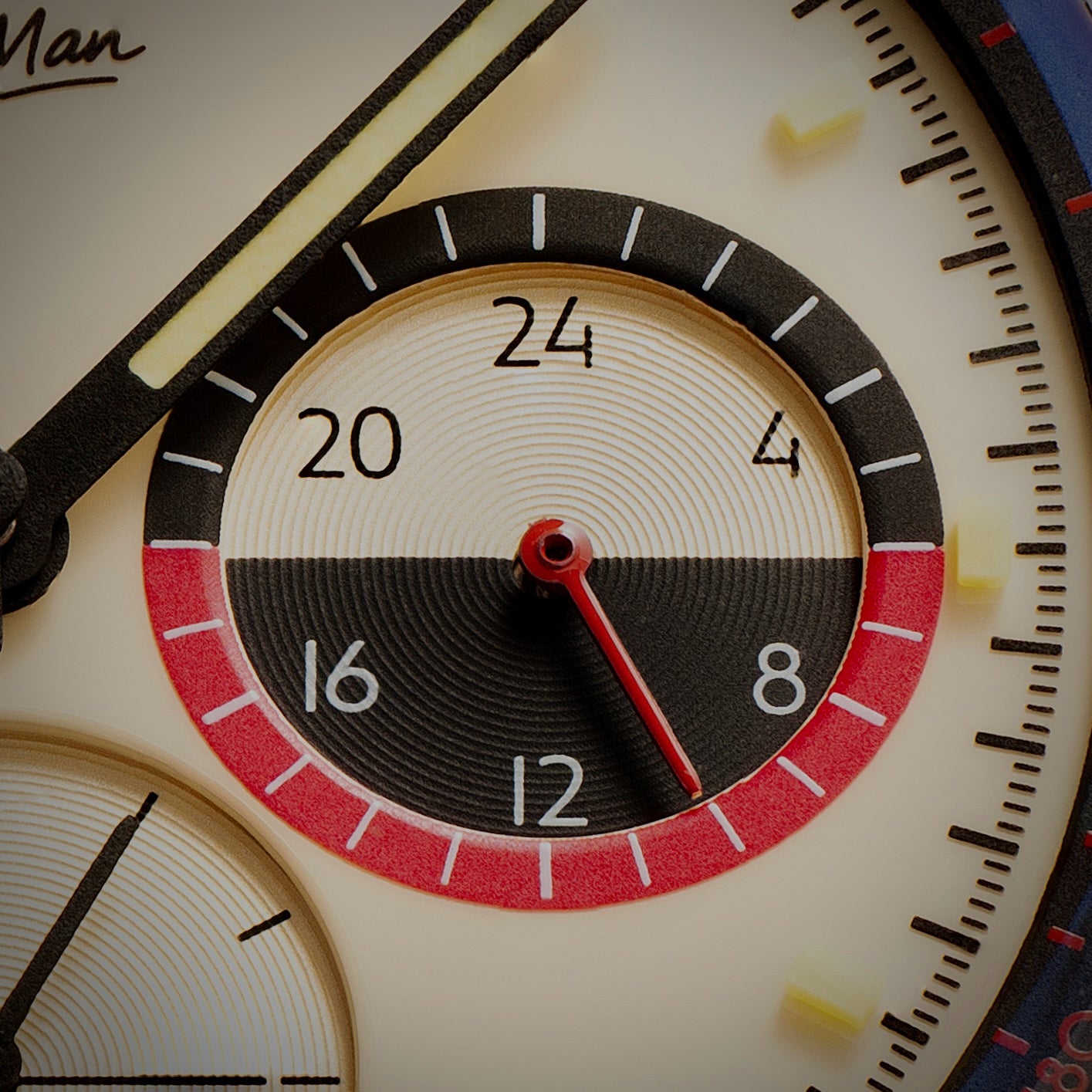 Macro of the lacquered dial with concentric subdials and a red accent